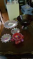 Overview of lot with ruby punch bowl, cups, platters, footed bowl