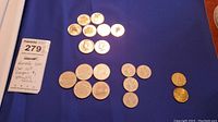Top view showing grouped coins on blue background with lot label.