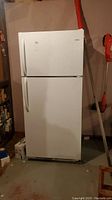 Full front view of the white Galaxy refrigerator showing both freezer and refrigerator doors.