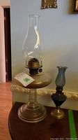 Both vintage oil lamps together showing size difference and design details