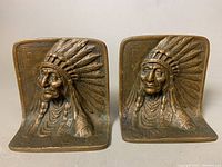 Close-up of the bronze Native American Chief bookend showing detailed bas-relief with a feather headdress.