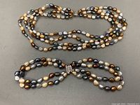 Full view of the 4-strand choker and 2-strand bracelet, showing the multi-toned baroque pearls and clasps.