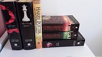 Five books standing upright showing titles and dust jackets to identify them