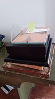 Photo of 5x7 photo frame with black wooden base and glass cover