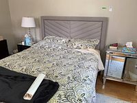 Full view of the headboard attached to a bed with bedding showing overall size and appearance.
