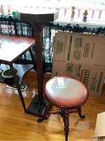 Piano stool and plant stand together showing overall size and style