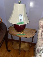 Photo of the pottery base table lamp with shade placed on the demi lune wooden table.