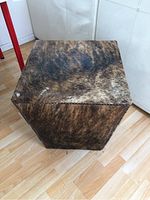 Top and angled view showing furry cowhide upholstery and studded trim on hexagonal side table.