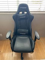 Front view of the black GTRACING office gamer chair highlighting the ergonomic design, cushions, and armrests.