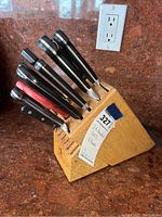 Full view of set in wooden block showing eight knives and scissors