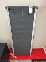 Front view of foldable pet ramp showing full length with metal sides and grey plastic surface