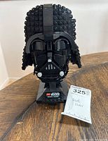 Front view of the LEGO Darth Vader bust on stand with identification plate and auction tag visible.
