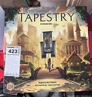 Front of Tapestry board game box showing artwork and title, unopened except plastic packaging removed