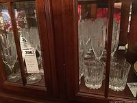 Multiple Park Lane Uptown glasses displayed inside a wooden cabinet