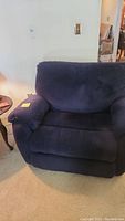 Front view of navy blue oversized La-Z-Boy recliner chair showing plush cushioned seat and armrests.