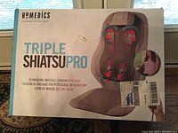 Front of box showing product image and branding with description of 3D kneading massage cushion with heat.