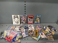 Group shot of assorted sports cards on metal shelving