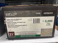 Photo of the nail box showing specifications, quantity, and brand
