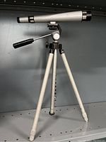 Photo of Sears 8463 telescope mounted on tripod stand showing overall condition and design. Included to verify actual item condition and details.
