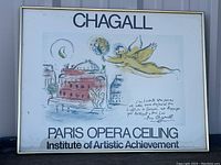 Full view of framed Chagall exhibit poster with illustration and handwritten signature on white background.