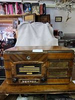 Front view of General Electric G71 vintage wooden radio showing tuning dial, knobs, buttons and speaker grille.