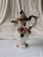 Front view of the antique Capodimonte porcelain pitcher vase showing detailed rose and handle.