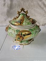 Front view of vintage Pereiras Valado hand-painted ceramic decorative covered bowl with floral and gold painted accents