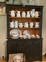 Front view showing two upper shelves with beadboard backing and four-panel door base