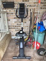 Front view of the full exercise bike showing frame, seat, and pedals