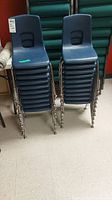 Stack of blue plastic and metal frame chairs showing front view.