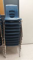 Front view of ten blue chairs stacked