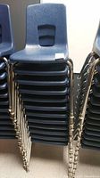 Stacks of blue chairs viewed from the side, showing multiple chairs in row