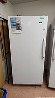 Front view of white upright refrigerator unit closed