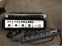 Photo showing EV EX18 Active Crossover, Behringer Powerplay HA8000 headphone amplifier, and Phonic Powerpod 408 powered mixer with cables.