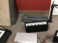 Wide view showing Samsung DVD player, Phonic mixer, Leprecon mixer, and stand on the floor with wires.