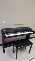 Frontal view of digital piano with bench