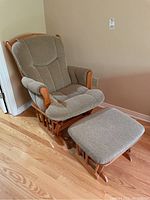 Full view of glider rocker and footstool showing wood frame and upholstery