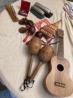 Full lot showing all musical instruments placed on fabric.