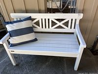 Front view of white wooden bench with cushion