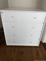 Front view of white four-drawer dresser