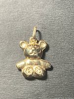 Front view of the 10k gold teddy bear charm showing detailed face and paws.
