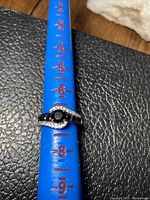 Ring on measuring tool showing size 7.