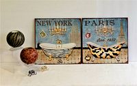 Photo shows set of ceramic animal print spherical t-light holders and metal wall art pieces depicting animal print clawfoot bathtubs with New York and Paris themes, and two small animal print brooches in front.