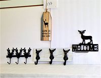 Photo showing three cast iron reindeer hook items
