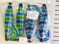 Four folded and packaged fabric hot air balloons showing striped patterns in green/blue and purple/sky blue colors.