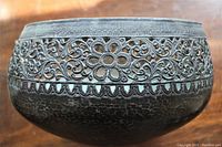 Close-up of the top half exterior showing detailed pierced floral and scrollwork band with scalloped edge and hand hammered trumpet shape body.