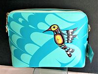 Front view of turquoise handbag featuring Hummingbird artwork by Francis Dick.