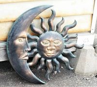 Full view of the celestial wooden wall art set showing moon and sun pieces side by side on the ground.