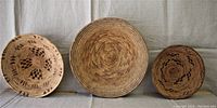 Front view of three woven baskets showing top patterns and sizes