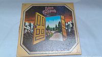 Front cover of Bruce Cockburn self-titled debut album showing the illustrated open door and landscape design.